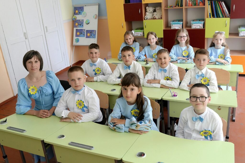 Students sitting in a class with teachers 